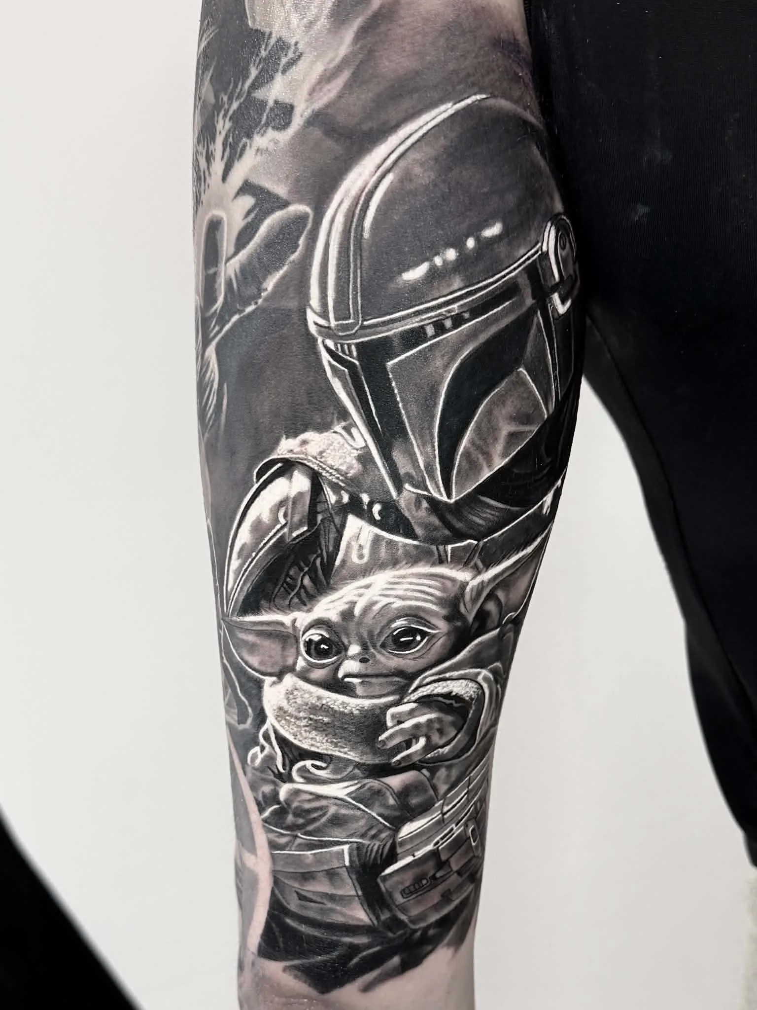 Black and grey Mandalorian and Grogu tattoo by Crouchy